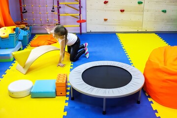 an autistic girl is treated in the form of a game by a psychologist, exercises on the ballancer...
