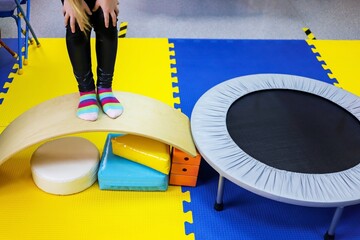 an autistic girl is treated in the form of a game by a psychologist, exercises on the ballancer help the brain, balance