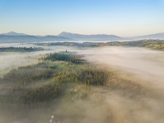 Morning mist in Ukrainian Carpathian mountains. Aerial drone view.