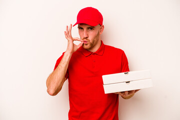 Young delivery caucasian man holding pizzas isolated on white background with fingers on lips keeping a secret.