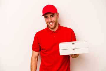 Young delivery caucasian man holding pizzas isolated on white background laughs out loudly keeping hand on chest.