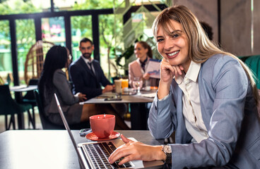 Portrait of young businesswoman working at cafe.