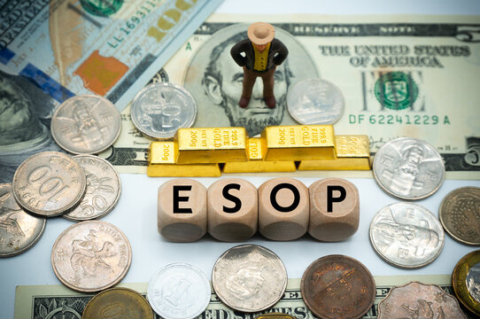 employee stock ownership plan (ESOP) gives workers ownership interest in the company.The word is written on money and gold background
