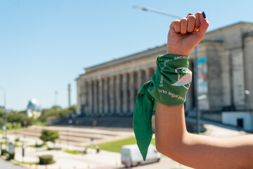 Fist with a green scarf symbolizing the feminist struggle for equality and legal abortion in Latin America. Legal, safe and free abortion. - obrazy, fototapety, plakaty