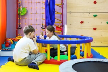 a boy and a girl play and are treated by a psychologist in the center, autism is not a sentence,...