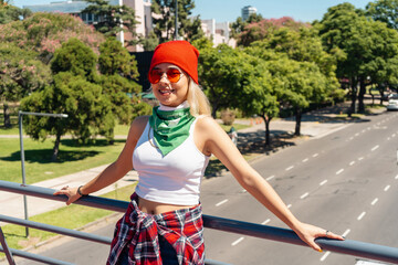 Beautiful young activist woman with a green scarf symbolizing the feminist fight for equality and...