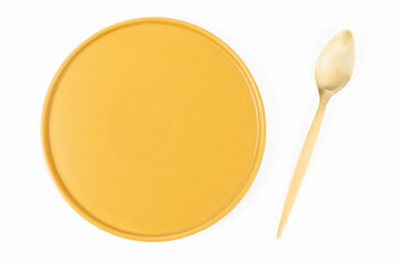 spoon next to plate on white background