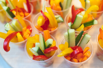 Beautifully decorated catering banquet table with variety of colorful vegetables and different vegan vegetarian snacks appetizers setting on corporate birthday party event or wedding celebration
