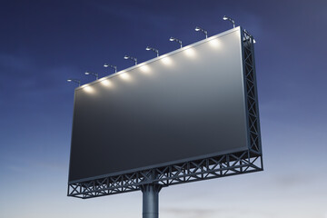 Blank black billboard on blue sky background at evening, front view. Mock up, advertising concept