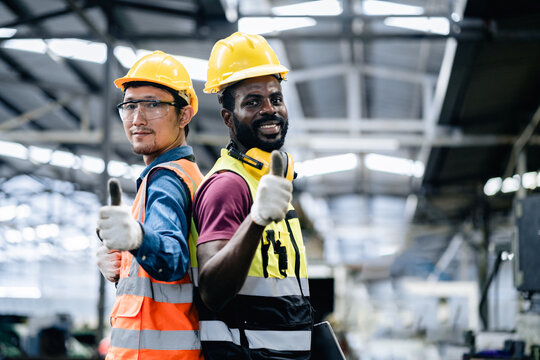 Two Factory Workers man or mechanics showing thumbs up in machinery repair factory, feeling happy, positive thinking work, services maintenance excellent.