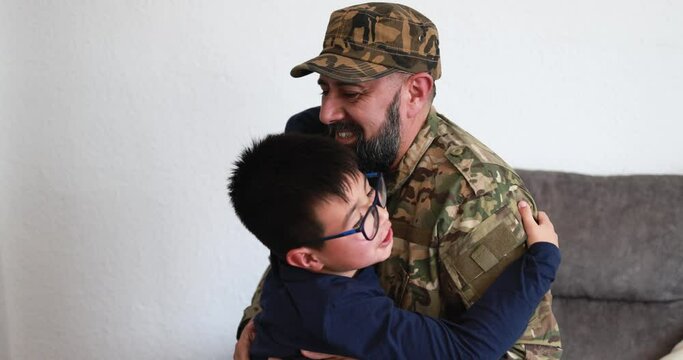 Military soldier hugging his son at home - Family moments and war concept