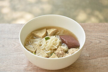 Vietnamese rice noodles or Pho with slice sausage and chop pork in soup on bowl