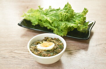 spicy chop pork Thai chili pasted topping boiled egg eat couple with fresh vegetable on plate