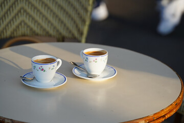 Two cups of espresso coffee on a coffee shop terrace from Paris, France.