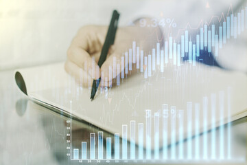 Double exposure of abstract creative financial diagram with hand writing in notebook on background, banking and accounting concept