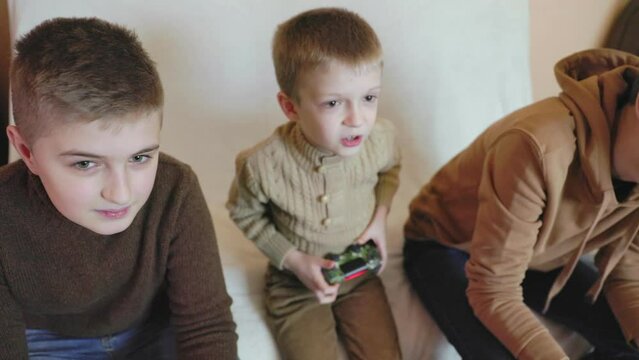 children playing on the console with joysticks in ruhs close-up