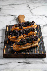 Eclairs with poppy seeds and cream. Top view. Free space for text