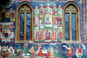 Fototapeta na wymiar Sucevitsa Monastery, Suceava County, Moldavia, Romania: One of the famous painted churches of Moldavia. Detail of the colorful medieval frescos on the Resurrection Church.