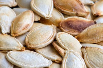Organic food, delicious. The roasted seeds of pumpkin. Dry fruit background. Selective focus.