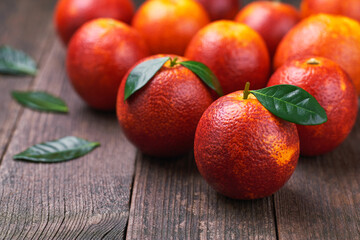 red blood oranges on a wooden table, selective focus.