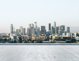 Fototapeta na wymiar Empty concrete dirty rooftop on the background of a beautiful LA city skyline at morning, mock up