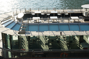 Top of a cruising ship with no tourists on it. Parked on the shore of Seine River in Paris, France.