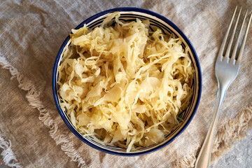 Fermented cabbage or sauerkraut in a bowl, top view