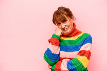 Middle age caucasian woman isolated on pink background who feels sad and pensive, looking at copy space.