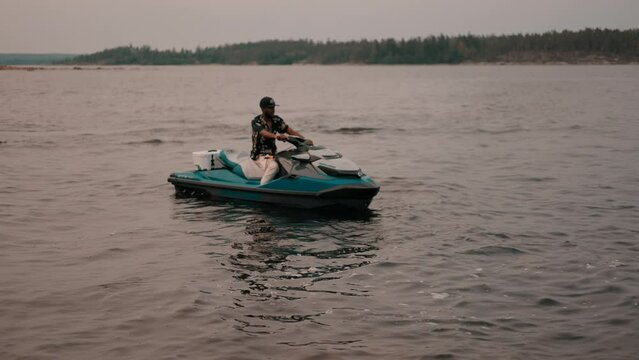Guys riding jet skis on blue water in Sweden.
