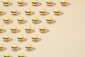 Trendy pattern made of candy hamburger on bright background. Diagonal copy space. Minimal concept.