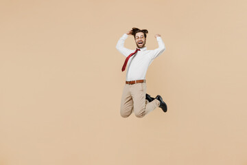 Fototapeta na wymiar Full body young successful employee business man corporate lawyer 20s wear white shirt red tie glasses work in office jump high do winner gesture isolated on plain beige background studio portrait