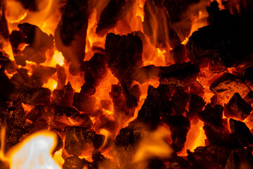 Close up photo on red coals in burning bonfire