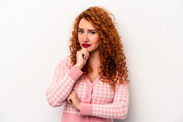 Young ginger caucasian woman isolated on white background thinking and looking up, being reflective, contemplating, having a fantasy.