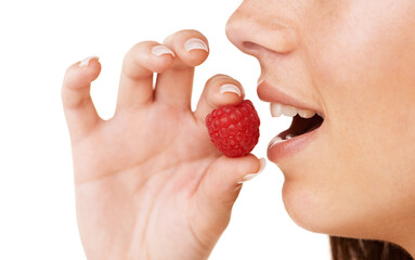 Savoring a delicious raspberry. Cropped profile of a woman about to eat a raspberry.