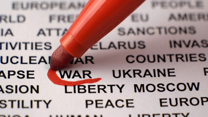 Closeup shot of WAR written on white paper with a red circle around it. Russian invasion of Ukraine concept. Sanctions. Crisis. Military activities. 