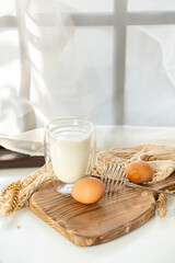 omelet making process, ingredients, eggs and milk on the table