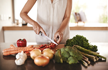 My body will thank me later. Cropped image of a woman preparing dinner at home.