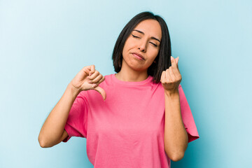 Fototapeta premium Young hispanic woman isolated on blue background showing that she has no money.