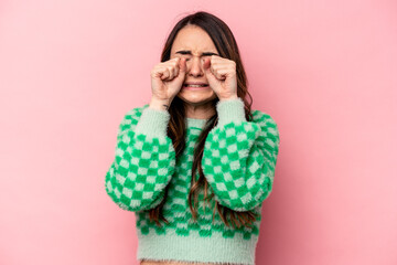 Young caucasian woman isolated on pink background whining and crying disconsolately.