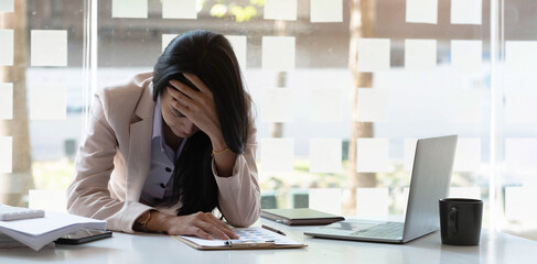 Businesswoman get stressed while having a problem at work in office