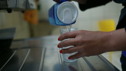 Woman serving water from jug person drinking water