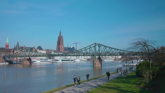 Eiserner Steg of Frankfurt am Main Bridge over the river Main with people on a sunny day