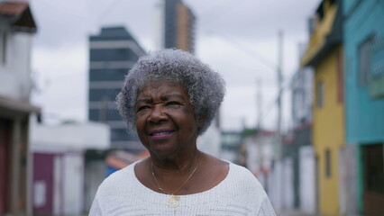 A senior black woman walking forward in urban street