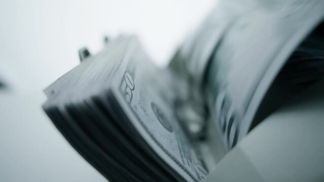 Money counting machine. Dollar banknotes on a bill counter. Modern bank equipment is processing usa currency. Automatic operations of cash. Banking or commercial activity and investment concept