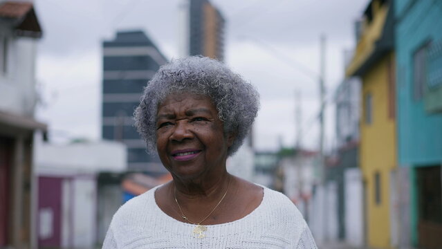 A Senior Black Woman Walking Forward In Urban Street