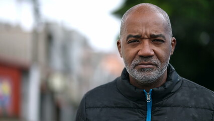 A senior black man portrait face with serious expression looking at camera - Powered by Adobe