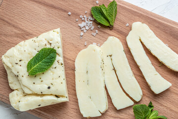 Grilled slices of halloumi cheese with grill marks and mint. Cyprus squeaky cheese with mint and...