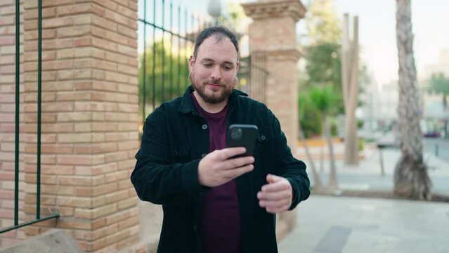 Young plus size man smiling confident making selfie by the smartphone at street