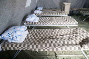 new tents for refugees from Ukraine.mobile building, temporary refugee camp.refugee camp.isolation tent at the refugee distribution center.Refugee boot camp