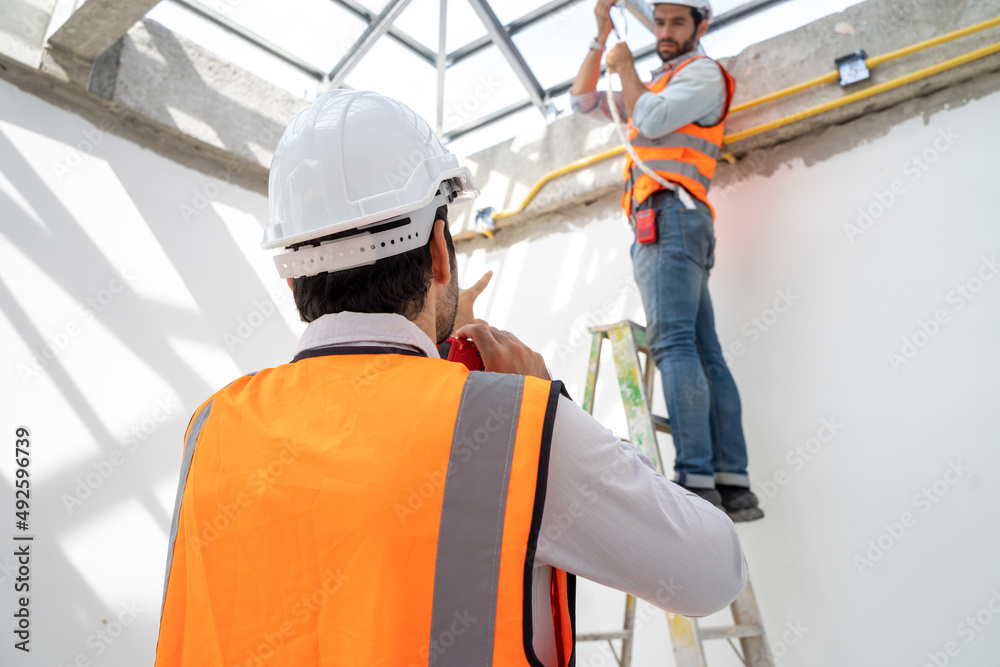 Aufkleber engineer technician watching team of workers on high steel platform at construction site,engineer wo